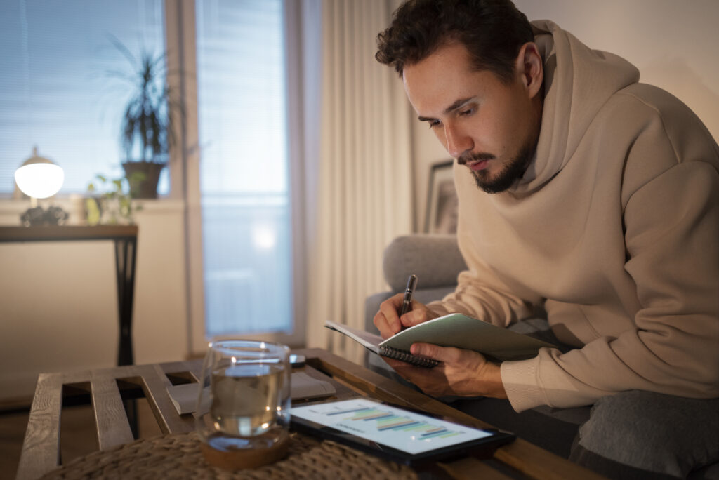 Young adult managing money with smartphone in a digital finance app interface, 2025 personal finance concept
